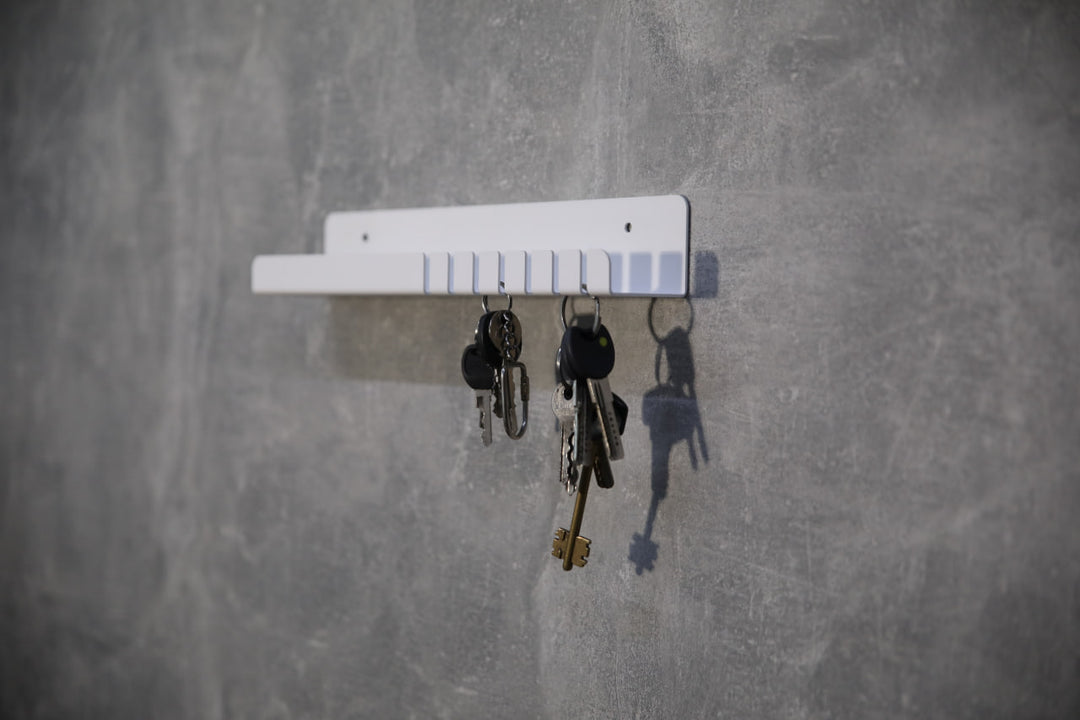 Wall-mounted-metal-key-holder-with-hooks-and-a-small-shelf-for-storing-keys-mail