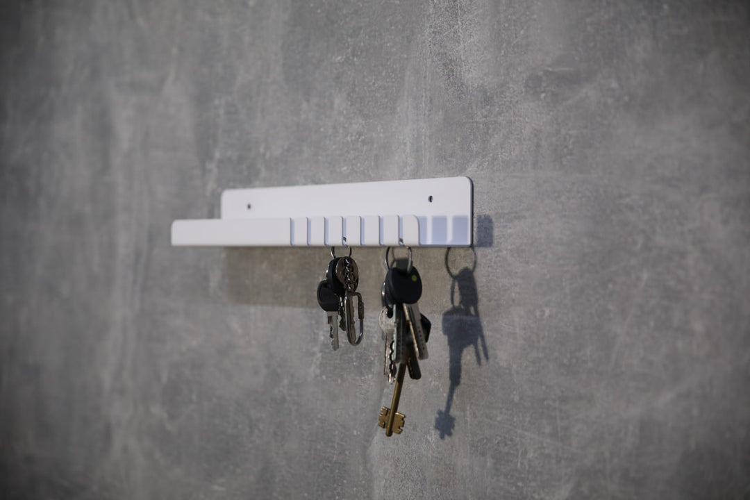 Wall-mounted-metal-key-holder-with-hooks-and-a-small-shelf-for-storing-keys-mail