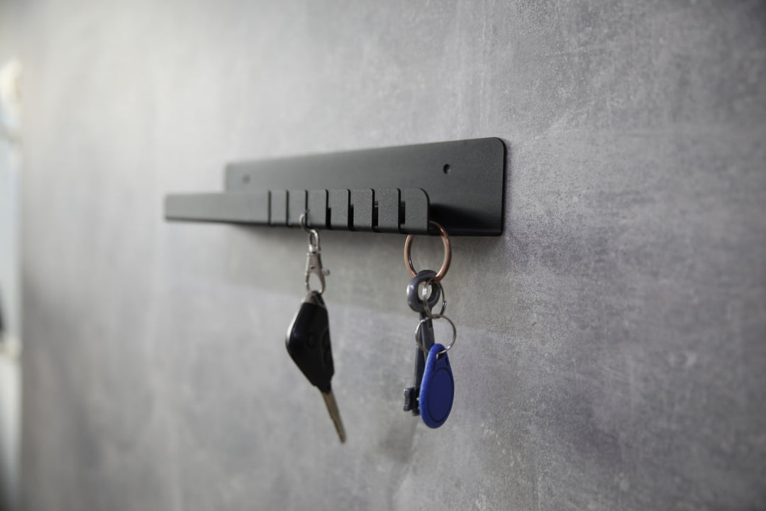 Wall-mounted-metal-key-holder-with-hooks-and-a-small-shelf-for-storing-keys-mail