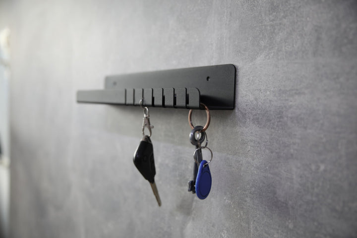 Wall-mounted-metal-key-holder-with-hooks-and-a-small-shelf-for-storing-keys-mail