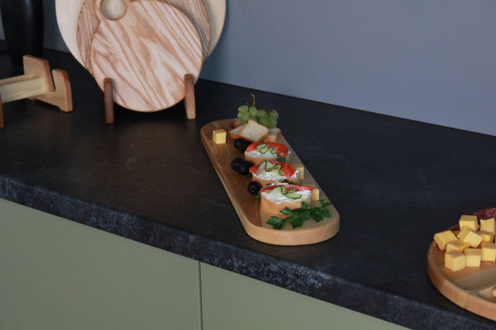 Elegant wooden serving board made from high-quality ash and oak. Perfect for serving cheese, charcuterie, or appetizers. Durable, stylish, and ideal for any kitchen or dining setting