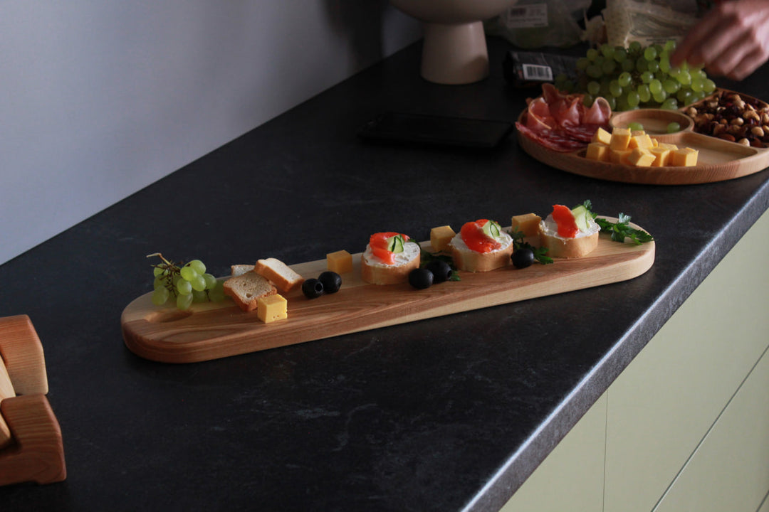 Elegant wooden serving board made from high-quality ash and oak. Perfect for serving cheese, charcuterie, or appetizers. Durable, stylish, and ideal for any kitchen or dining setting