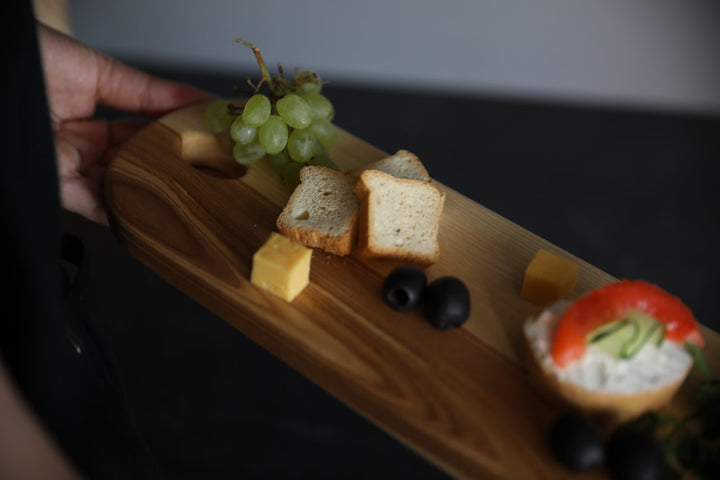 Elegant wooden serving board made from high-quality ash and oak. Perfect for serving cheese, charcuterie, or appetizers. Durable, stylish, and ideal for any kitchen or dining setting