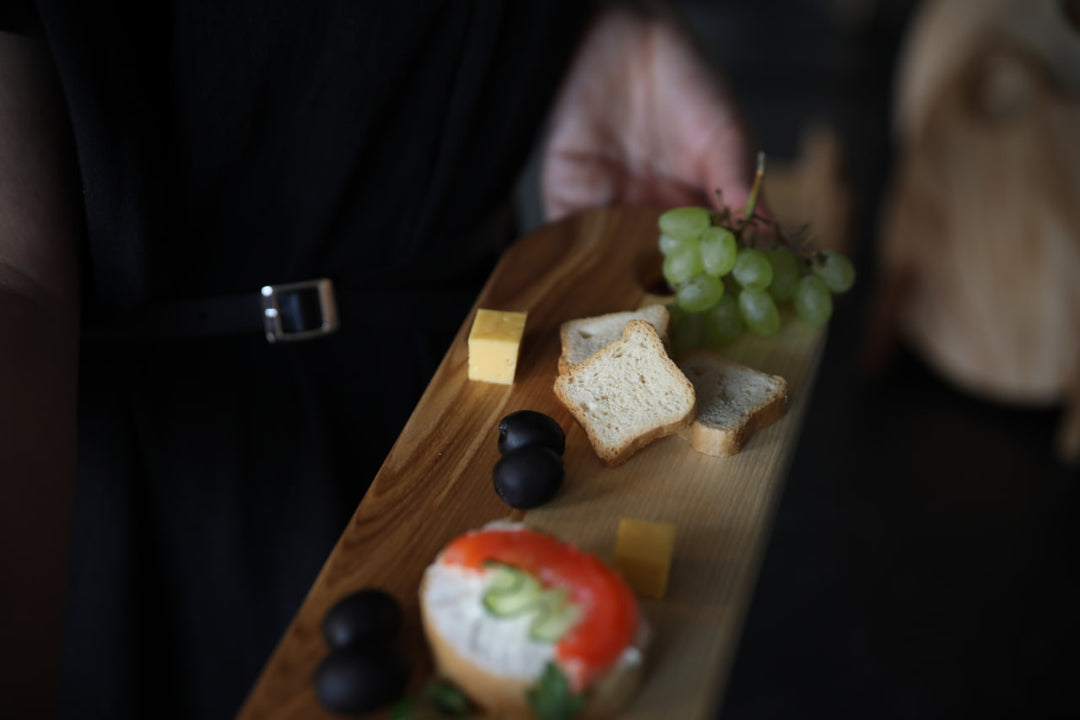 Elegant wooden serving board made from high-quality ash and oak. Perfect for serving cheese, charcuterie, or appetizers. Durable, stylish, and ideal for any kitchen or dining setting