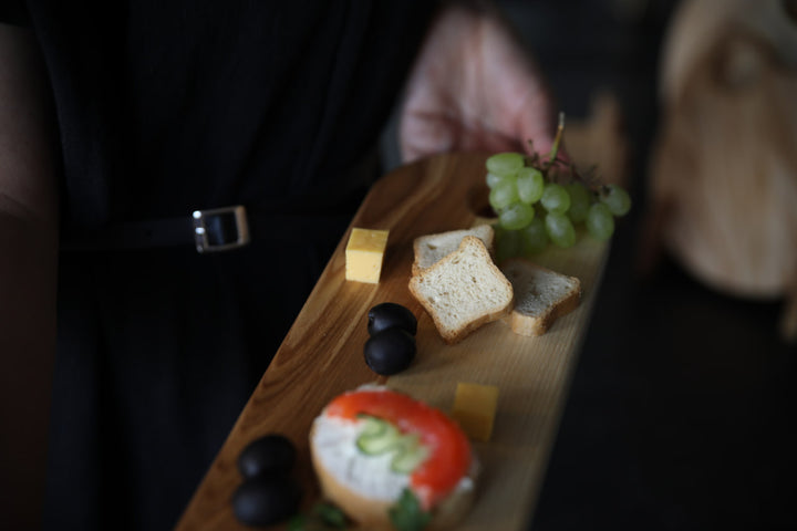 Elegant wooden serving board made from high-quality ash and oak. Perfect for serving cheese, charcuterie, or appetizers. Durable, stylish, and ideal for any kitchen or dining setting