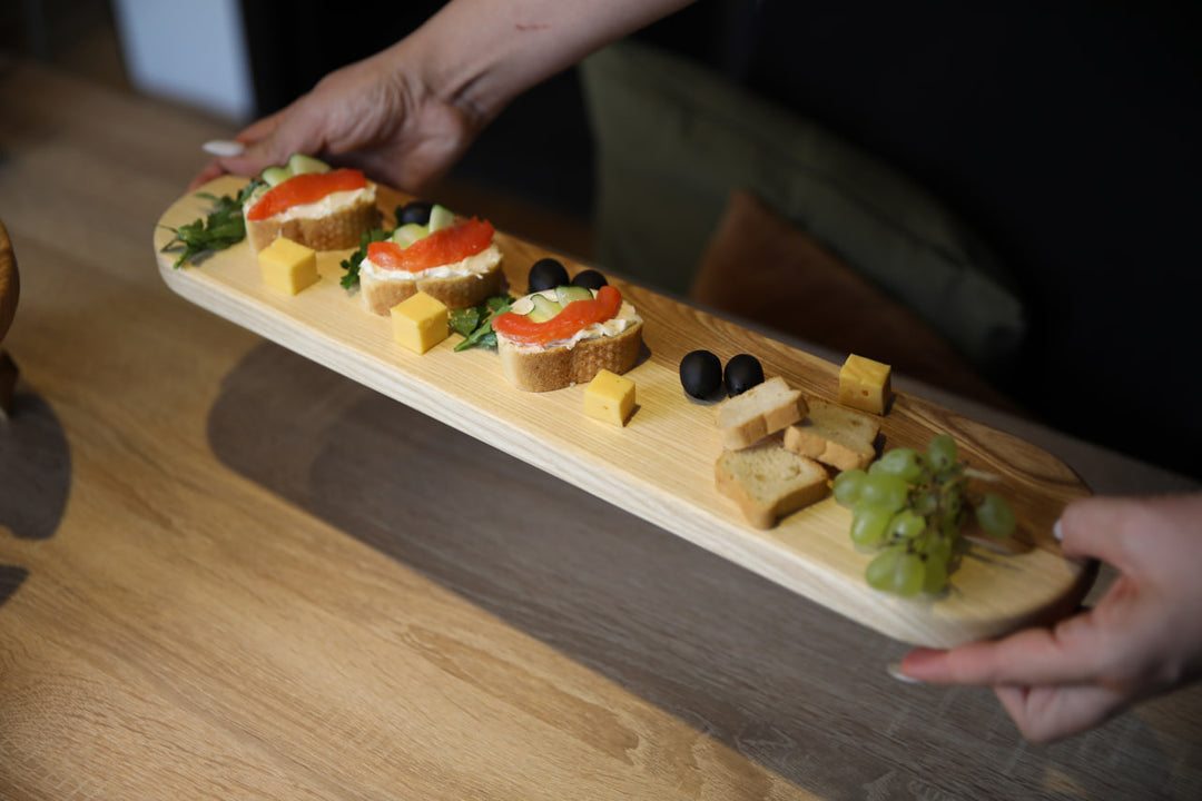 Elegant wooden serving board made from high-quality ash and oak. Perfect for serving cheese, charcuterie, or appetizers. Durable, stylish, and ideal for any kitchen or dining setting