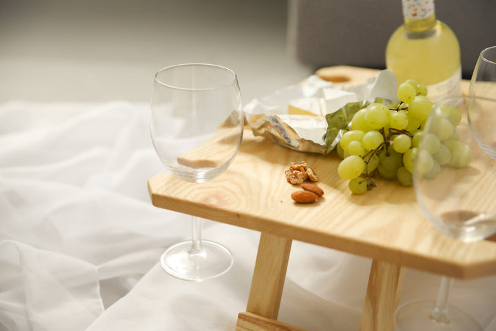 Outdoor-wine-table-with-slots-for-glasses-and-bottle