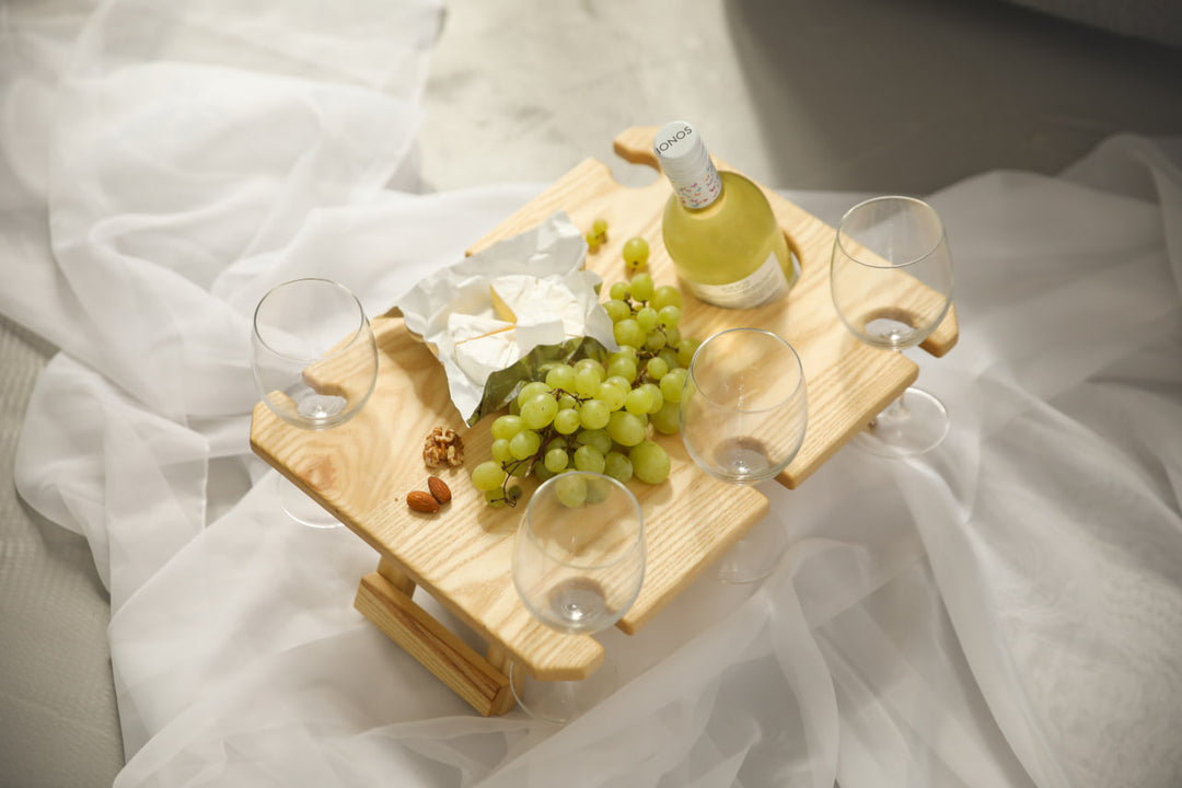 Outdoor-wine-table-with-slots-for-glasses-and-bottle