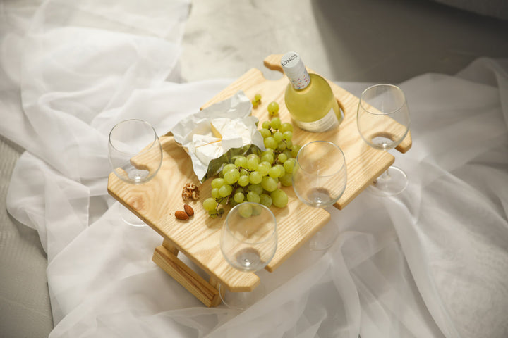 Outdoor-wine-table-with-slots-for-glasses-and-bottle