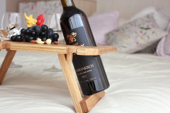 Outdoor-wine-table-with-slots-for-glasses-and-bottle