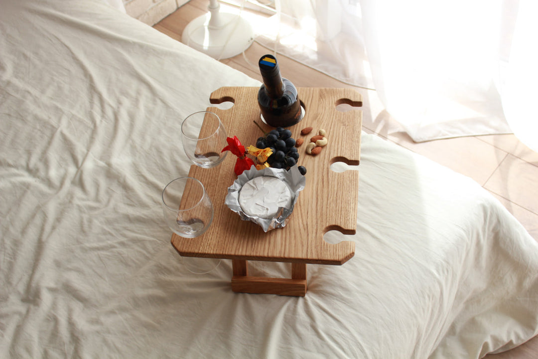 Outdoor-wine-table-with-slots-for-glasses-and-bottle