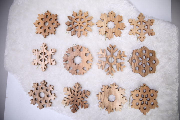 Natural-ash-wood-snowflake-ornament-with-detailed-carving-and-smooth-finish
