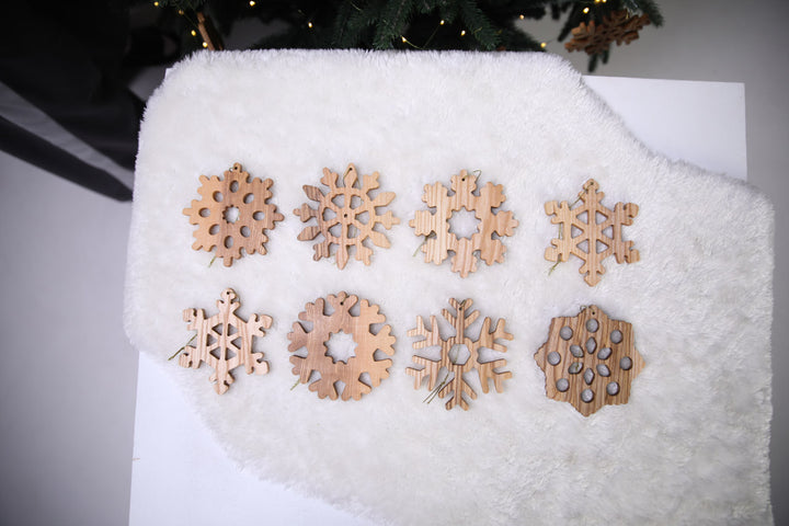 Natural-ash-wood-snowflake-ornament-with-detailed-carving-and-smooth-finish