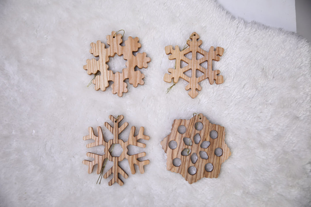 Natural-ash-wood-snowflake-ornament-with-detailed-carving-and-smooth-finish