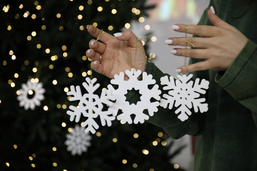 Hands-showing-white-plywood-snowflake-Christmas-decorations