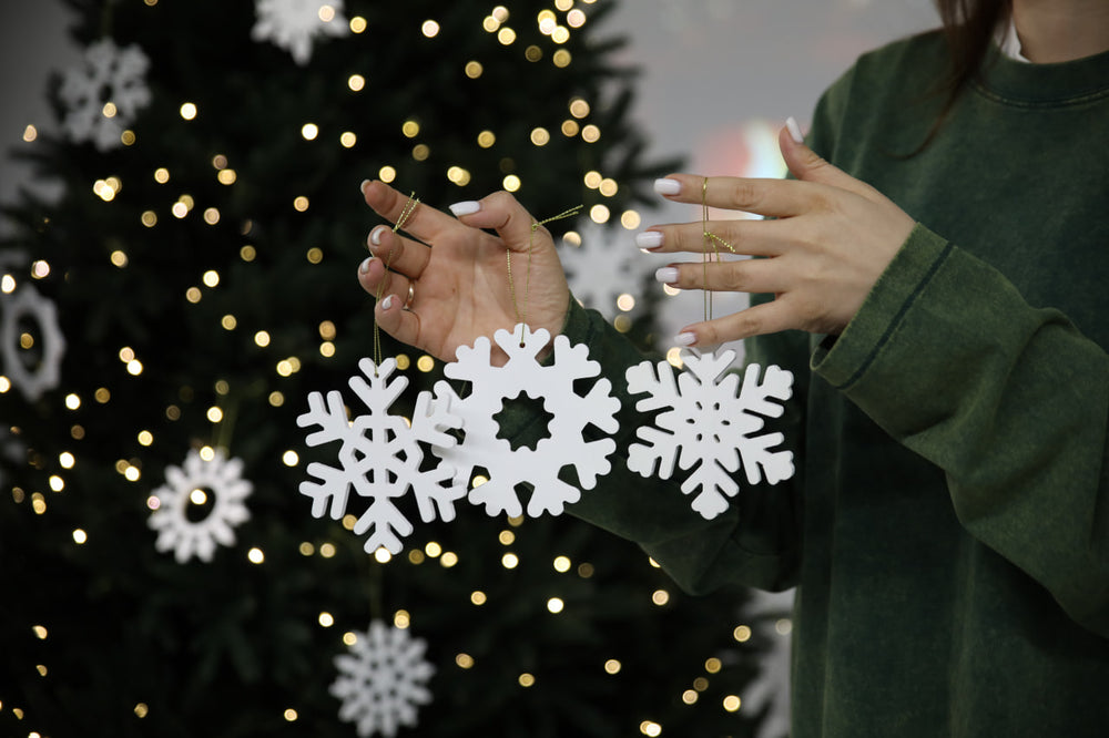 Hands-showing-white-plywood-snowflake-Christmas-decorations
