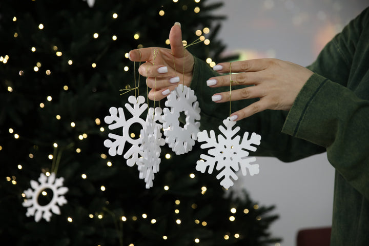 Hands-showing-white-plywood-snowflake-Christmas-decorations