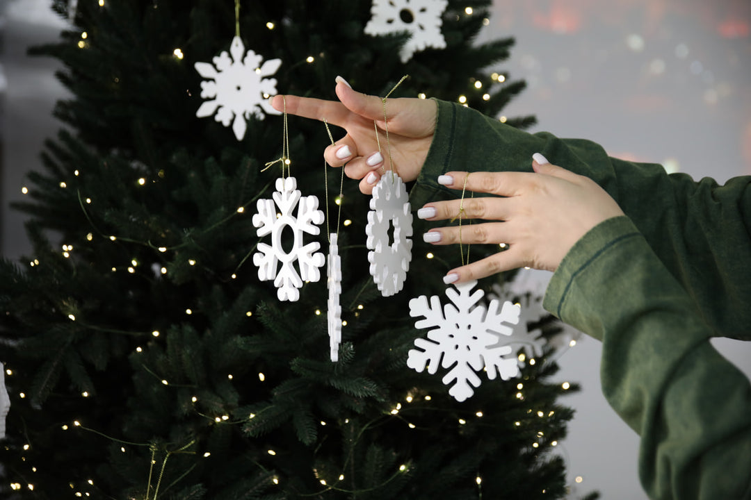 Hands-showing-white-plywood-snowflake-Christmas-decorations