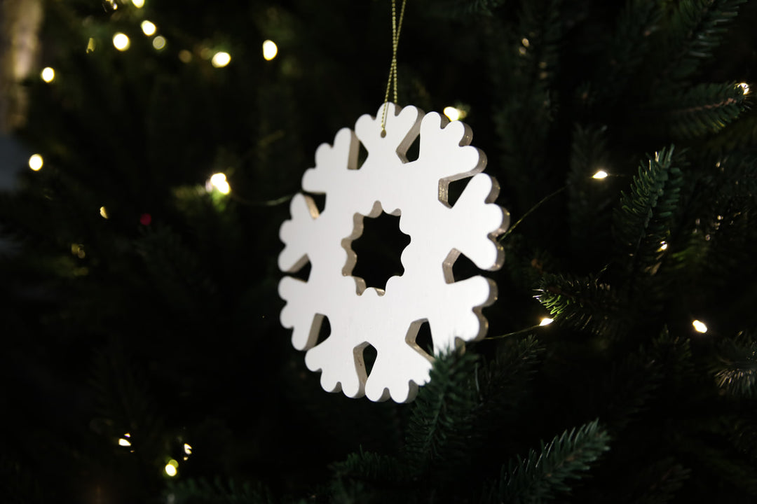 Hands-showing-white-plywood-snowflake-Christmas-decorations