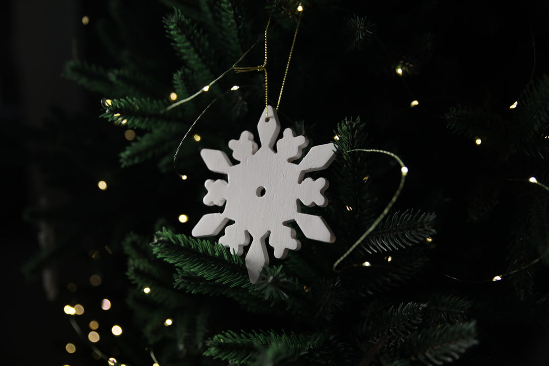 Hands-showing-white-plywood-snowflake-Christmas-decorations