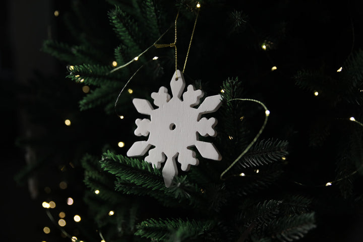 Hands-showing-white-plywood-snowflake-Christmas-decorations