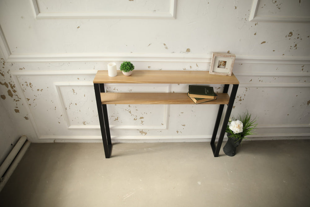 Slim-wood-and-metal-console-table-placed-along-a-hallway-wall