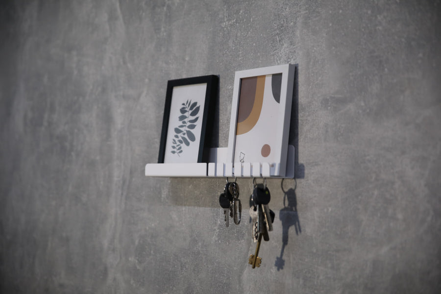 Wall-mounted-metal-key-holder-with-hooks-and-a-small-shelf-for-storing-keys-mail