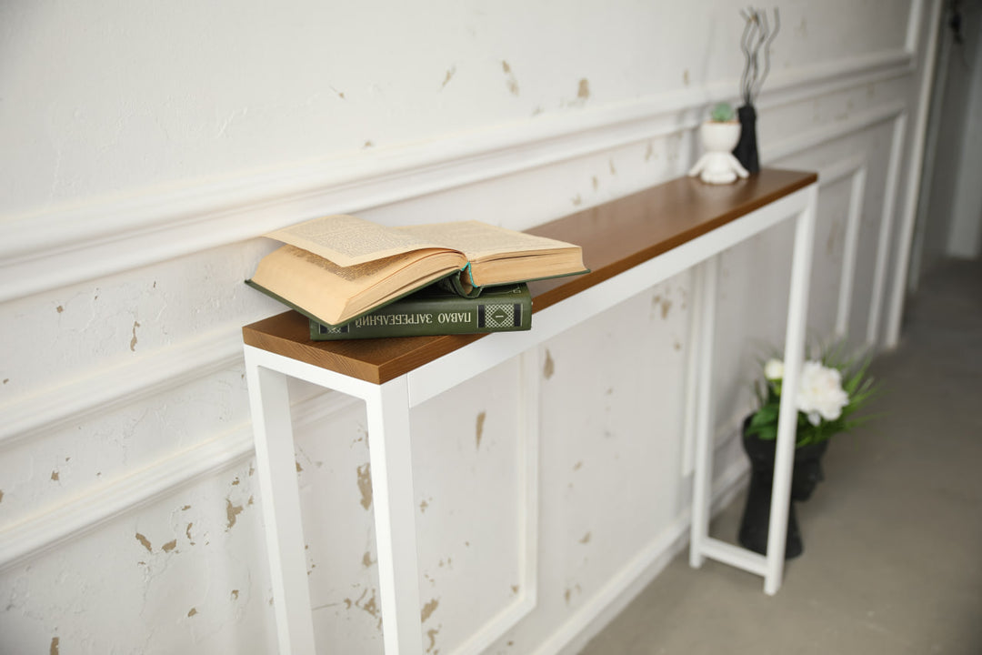 Vintage-style-wood-and-iron-console-table-against-a-wall-with-decor-on-top