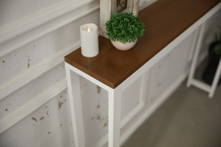 Vintage-style-wood-and-iron-console-table-against-a-wall-with-decor-on-top