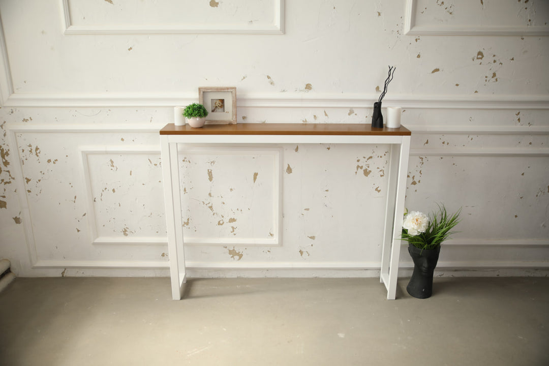 Vintage-style-wood-and-iron-console-table-against-a-wall-with-decor-on-top
