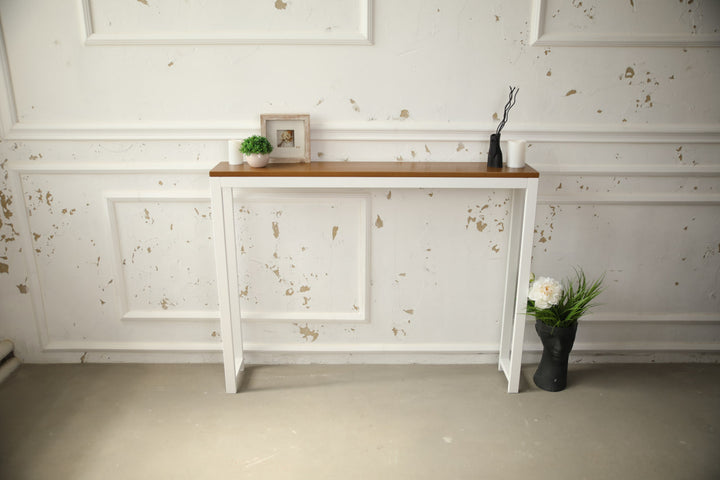 Vintage-style-wood-and-iron-console-table-against-a-wall-with-decor-on-top