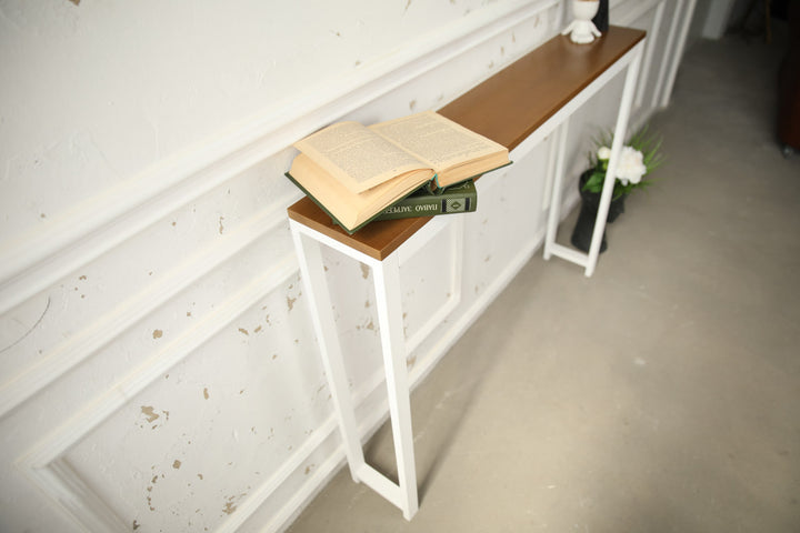 Vintage-style-wood-and-iron-console-table-against-a-wall-with-decor-on-top