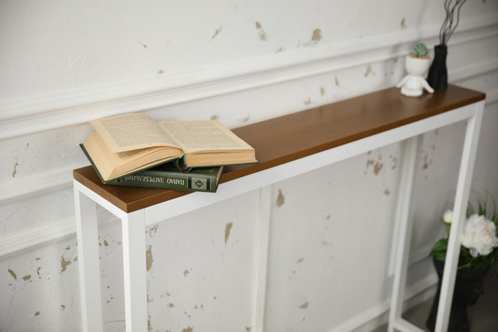 Vintage-style-wood-and-iron-console-table-against-a-wall-with-decor-on-top