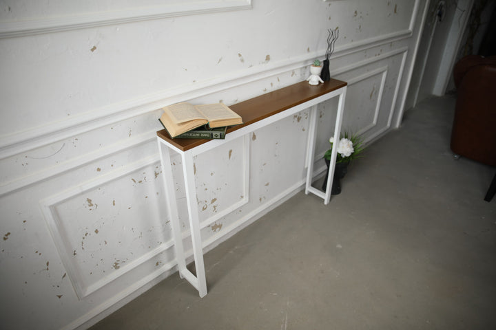 Vintage-style-wood-and-iron-console-table-against-a-wall-with-decor-on-top