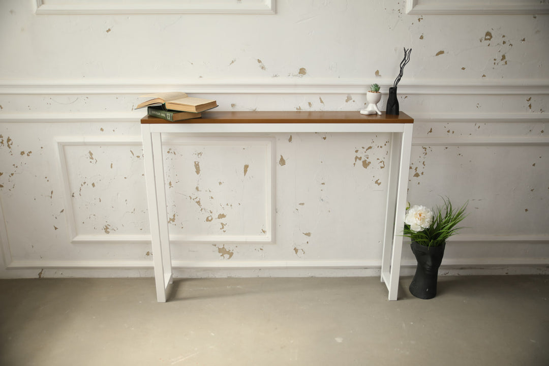 Vintage-style-wood-and-iron-console-table-against-a-wall-with-decor-on-top